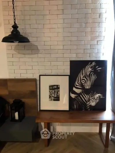 Stylish interior with brick wall, wooden bench, and zebra artwork for modern living room.