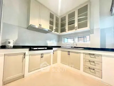 Modern kitchen with sleek cabinetry and ample counter space in a bright, airy setting.