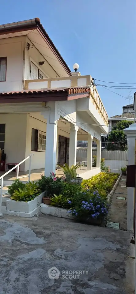 Charming two-story house with lush garden and spacious balcony, perfect for family living.