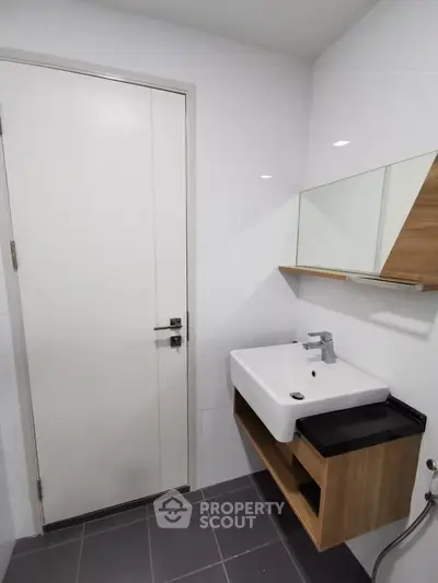 Modern bathroom with sleek sink and stylish mirror cabinet in a contemporary home.