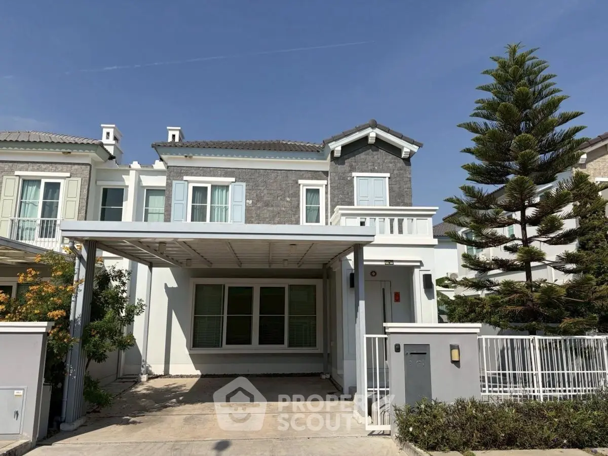 Charming two-story house with modern facade and spacious driveway in a serene neighborhood.