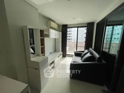 Modern living room with sleek furniture and large windows offering ample natural light.