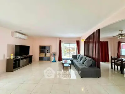 Spacious living room with modern furniture and large windows for natural light.