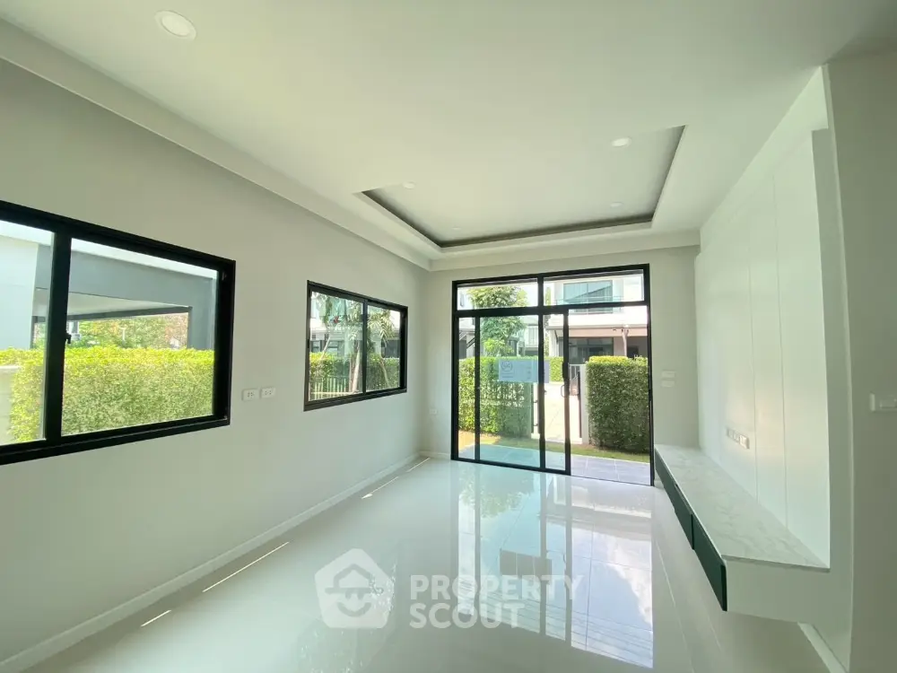 Spacious modern living room with large windows and garden view