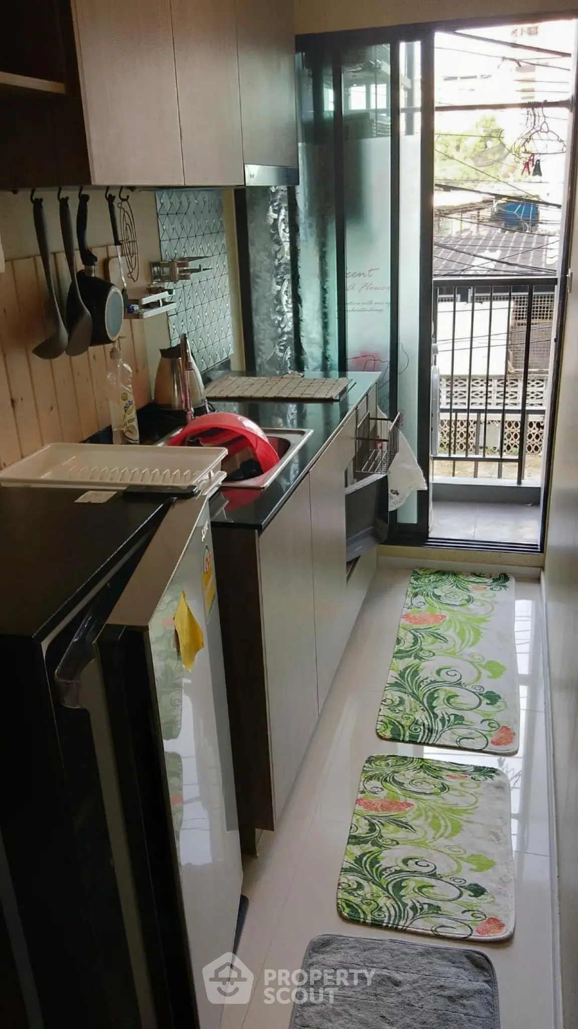 Compact kitchen with modern appliances and balcony view