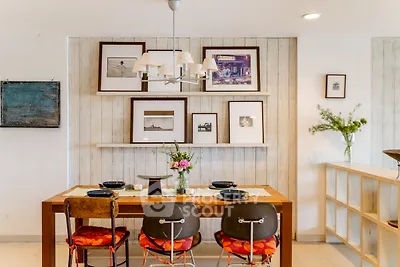 Charming dining area with rustic decor and stylish wall art in a cozy home setting.