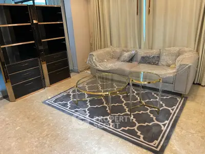 Modern living room with elegant furniture and stylish decor, featuring a plush sofa and chic coffee tables.