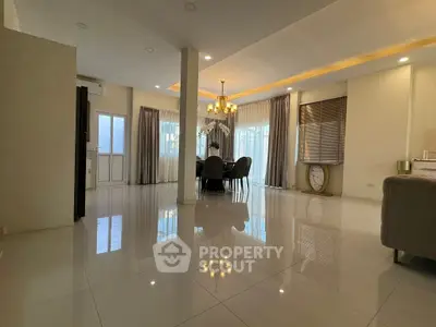 Spacious modern living room with elegant chandelier and large windows