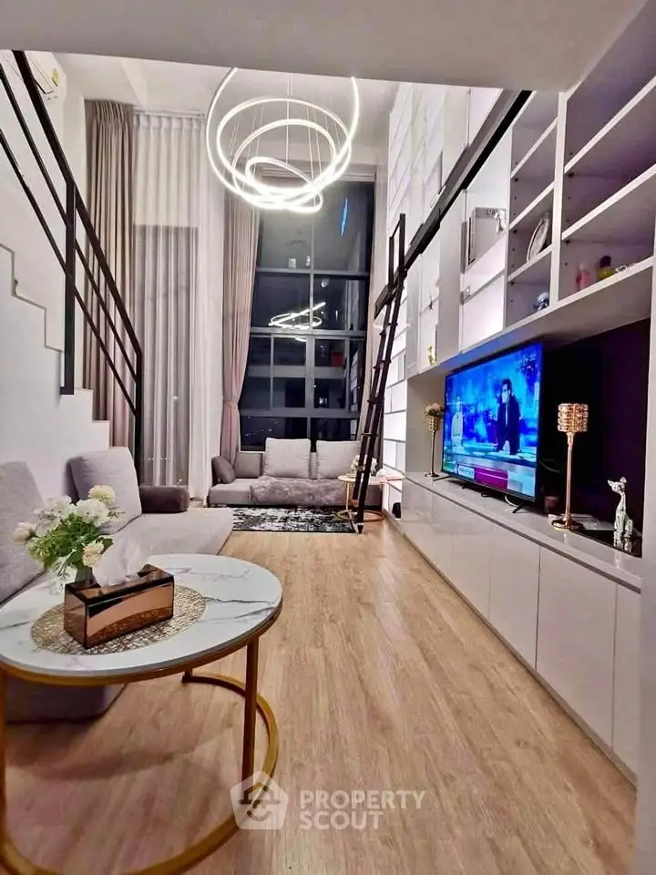 Modern living room with high ceilings, stylish lighting, and elegant decor in a chic apartment.