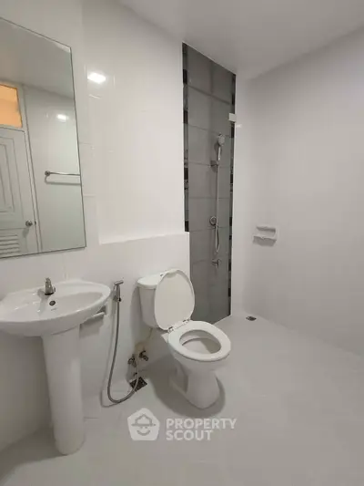 Modern minimalist bathroom with sleek fixtures and white tiles