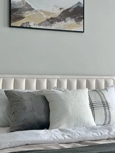 Elegant bedroom with plush pillows and modern art decor