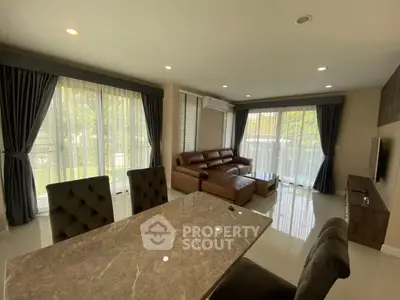 Spacious living room with modern furniture and large windows for natural light