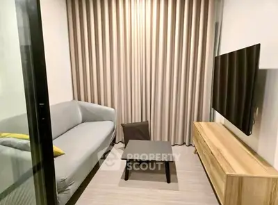 Modern living room with sleek sofa and wall-mounted TV