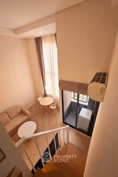 Modern duplex apartment with cozy living area and large windows