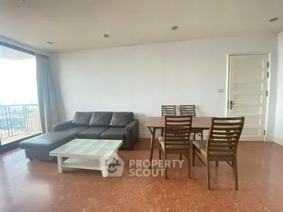 Spacious living room with modern furniture and balcony view