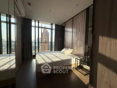 Luxurious bedroom with floor-to-ceiling windows offering stunning city views in a modern apartment.