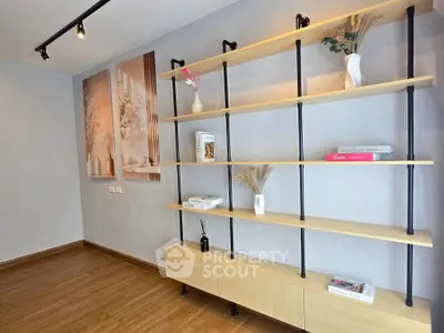 Modern living room with stylish wooden shelving and elegant decor accents.