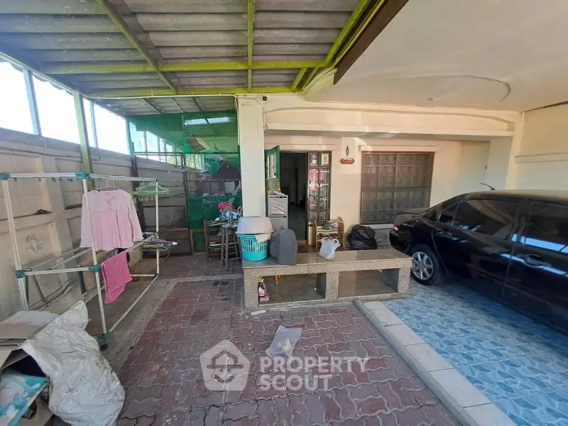 Spacious covered parking area with laundry space and storage potential.