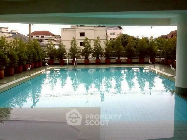 Luxurious residential pool with serene ambiance and lush greenery