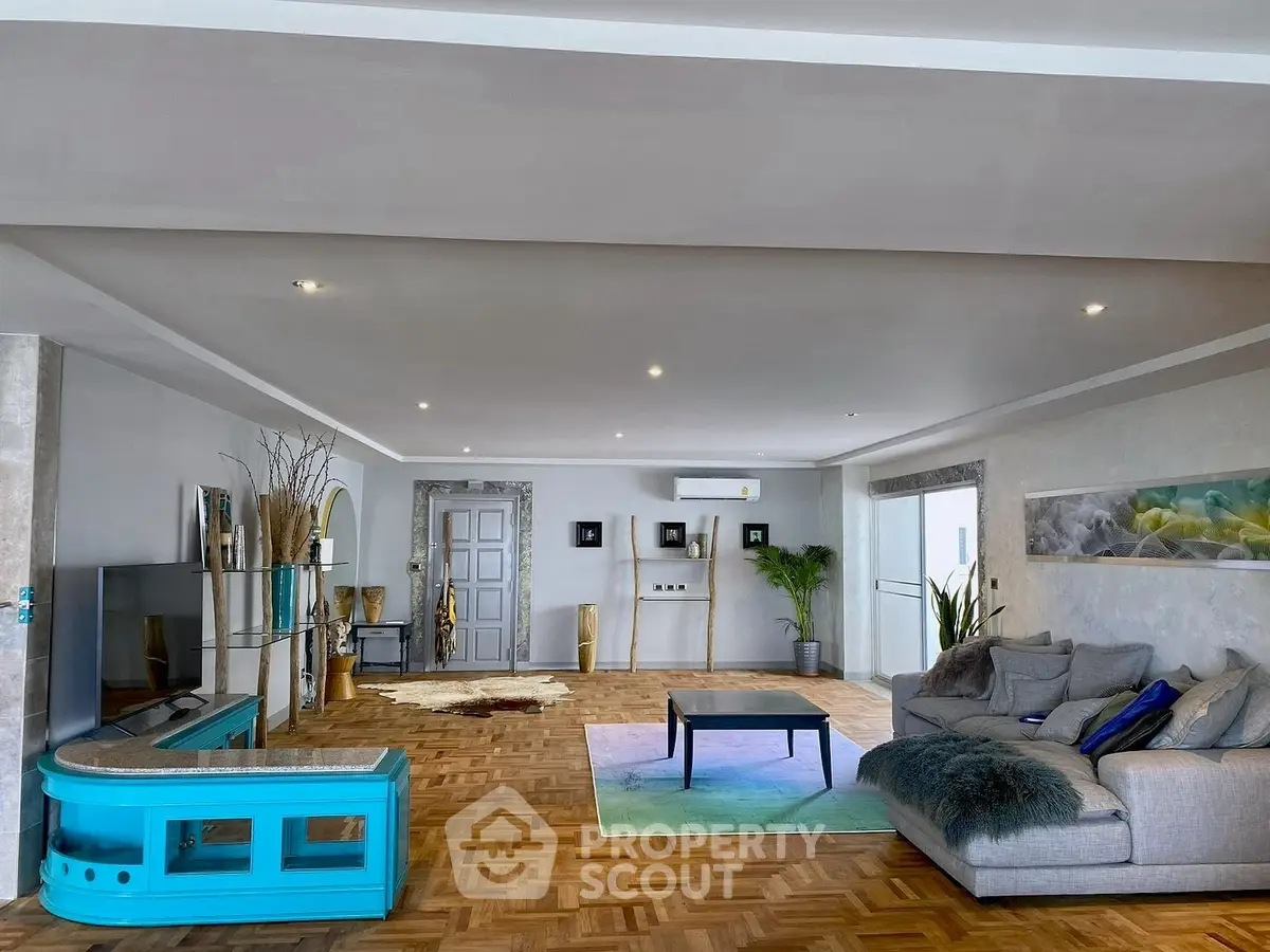 Spacious and stylish living room with modern decor and parquet flooring