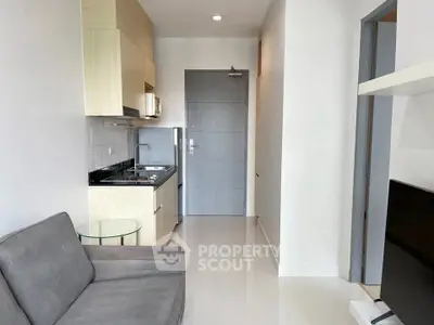 Modern compact apartment with sleek kitchen and cozy living area.