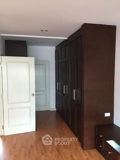 Spacious bedroom with elegant wooden wardrobe and modern design