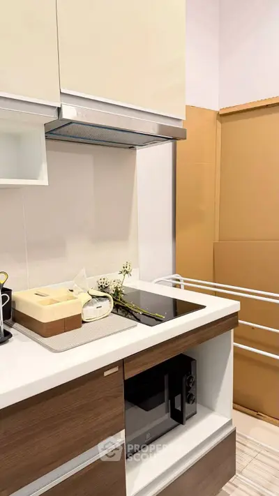Modern kitchen with sleek cabinetry and built-in appliances, featuring a compact design ideal for urban living.
