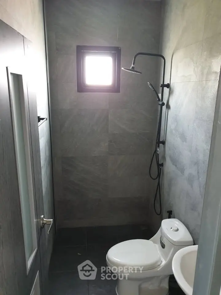 Compact modern bathroom with shower and toilet in sleek design