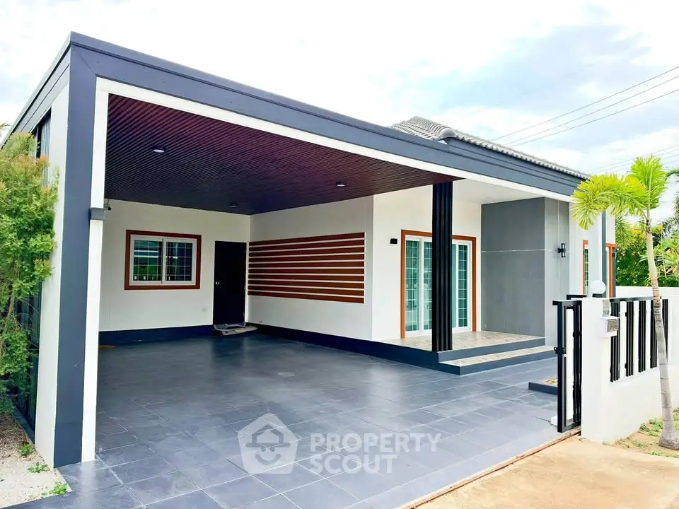 Modern single-story house with sleek design and spacious carport