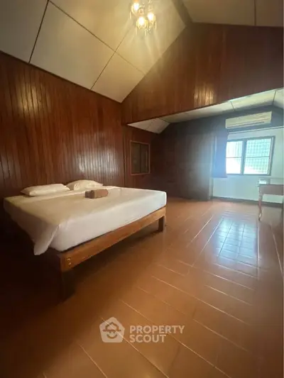 Spacious wooden bedroom with natural light and cozy ambiance