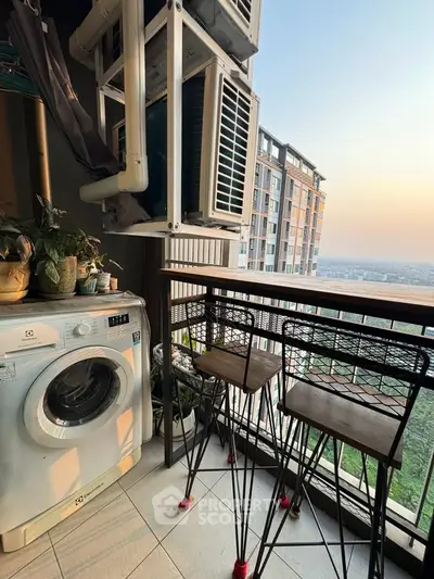 Charming balcony with city view, featuring a washing machine and stylish seating area.