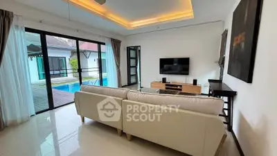 Luxurious living room with pool view and modern decor