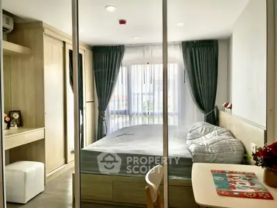 Cozy bedroom with modern furnishings and large window for natural light