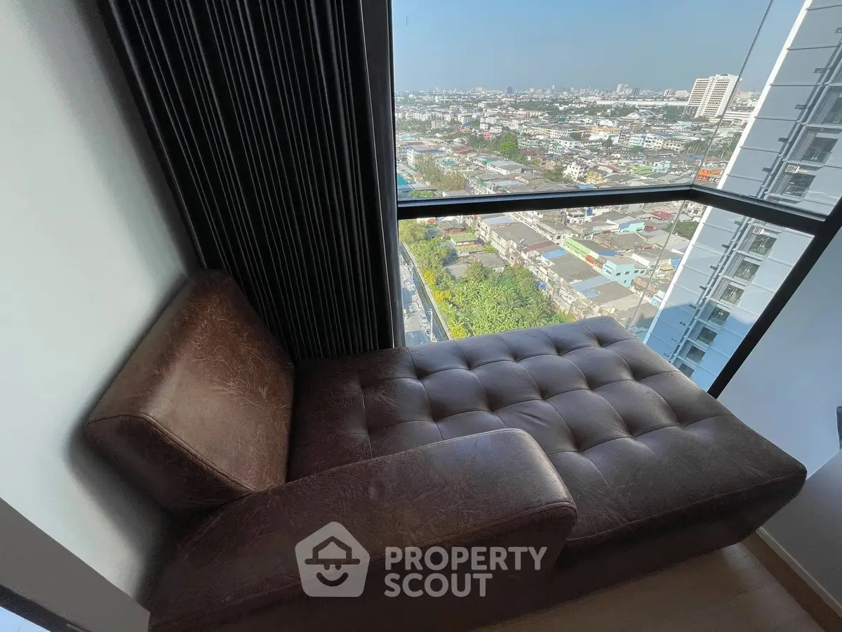 Luxurious corner unit with stunning city view from a cozy leather chaise lounge.