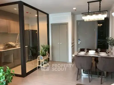 Modern dining area with glass partitioned kitchen in stylish apartment