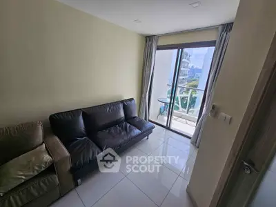 Modern living room with sleek sofa and balcony view