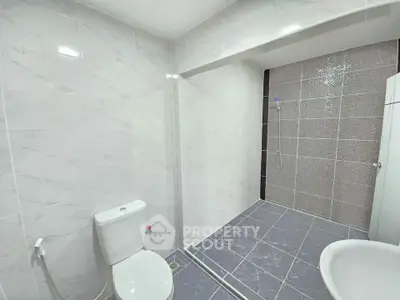 Spacious modern bathroom with sleek tiles and open shower design