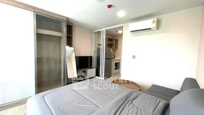 Modern bedroom with sleek design, featuring a cozy bed, TV, and air conditioning for ultimate comfort.