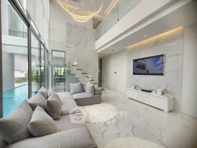 Luxurious modern living room with high ceilings and pool view, featuring elegant marble flooring and stylish decor.