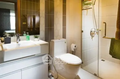 Modern bathroom with glass shower and sleek fixtures in a contemporary home.