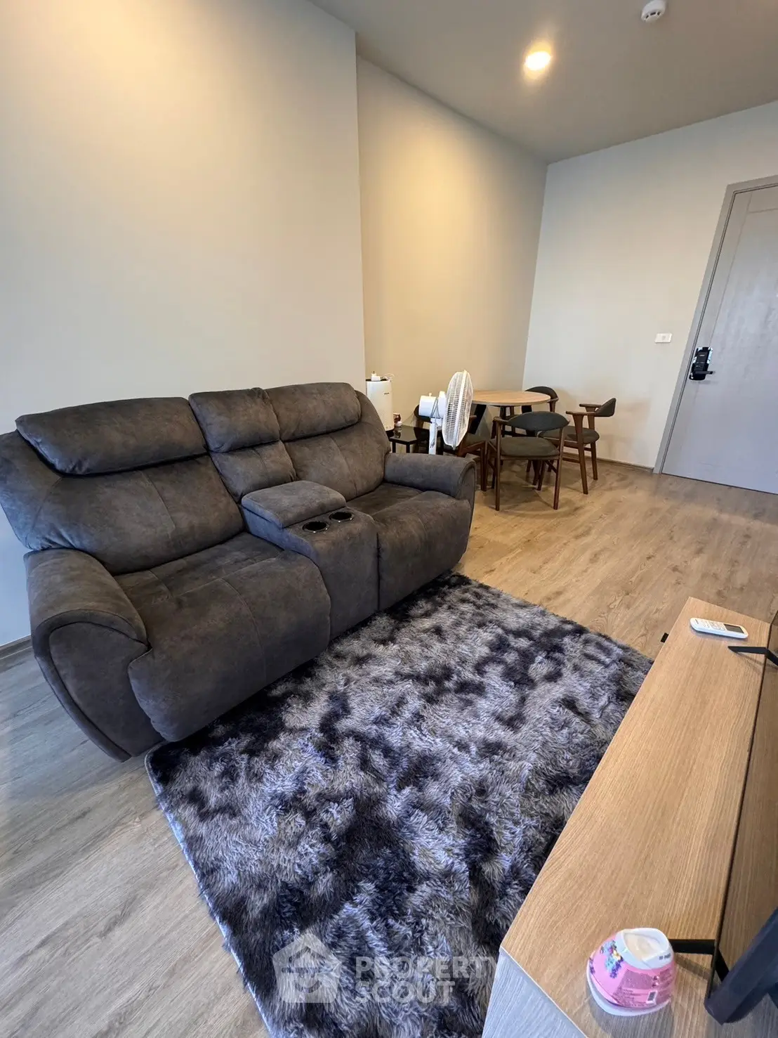 Modern living room with plush sofa and stylish dining area, perfect for cozy gatherings.