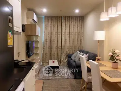Cozy living room with modern decor and dining area in open layout apartment.
