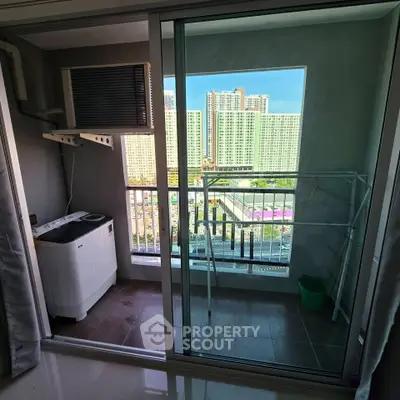 Modern apartment balcony with washing machine and city view, perfect for urban living.