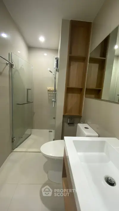 Modern bathroom with glass shower and sleek fixtures