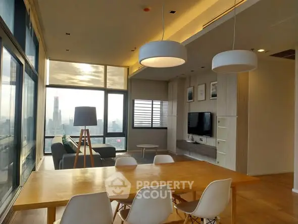 Modern living room with city view, stylish lighting, and elegant dining area.
