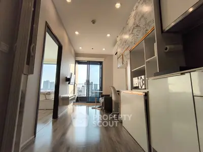 Modern apartment interior with sleek design and city view balcony, featuring open layout and stylish furnishings.