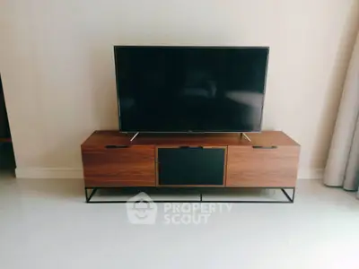 Modern living room with sleek TV stand and flat-screen television
