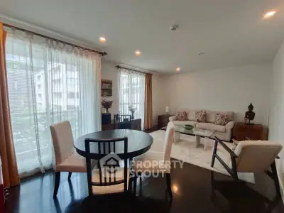 Spacious living room with elegant decor and large windows in modern apartment