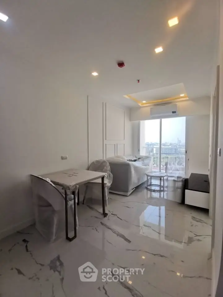 Modern living room with marble flooring and city view, featuring sleek furniture and large windows.