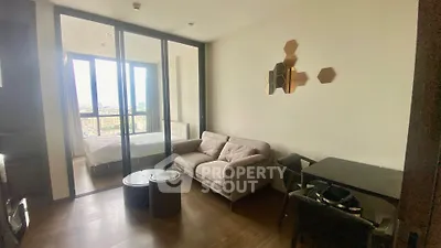 Modern apartment with cozy living room and bedroom view, featuring stylish decor and natural light.